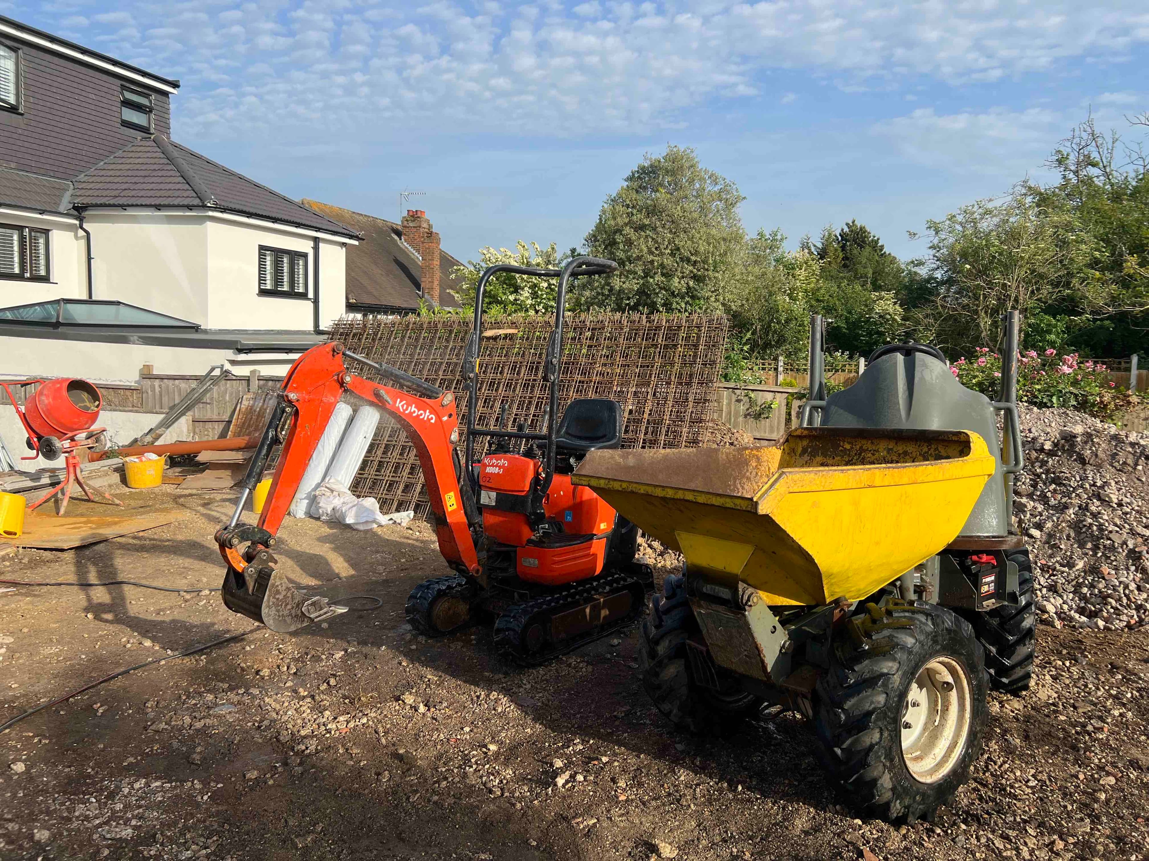 Excavator and construction equipment during groundworks at Chigwell residential project